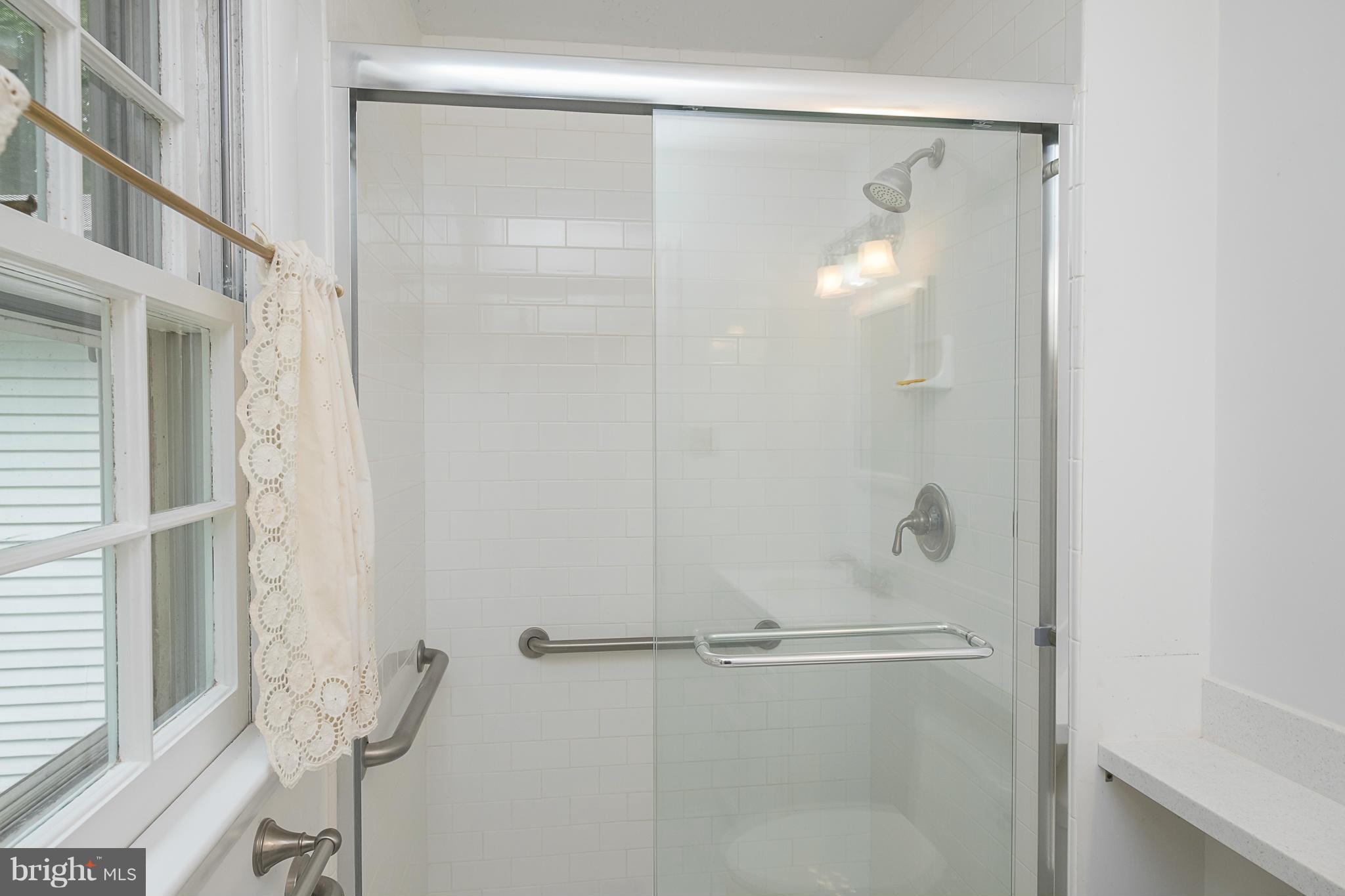 10836 Harding Road Laurel, MD 20723 - Photo 14 of 25 a bathroom with a glass shower door
