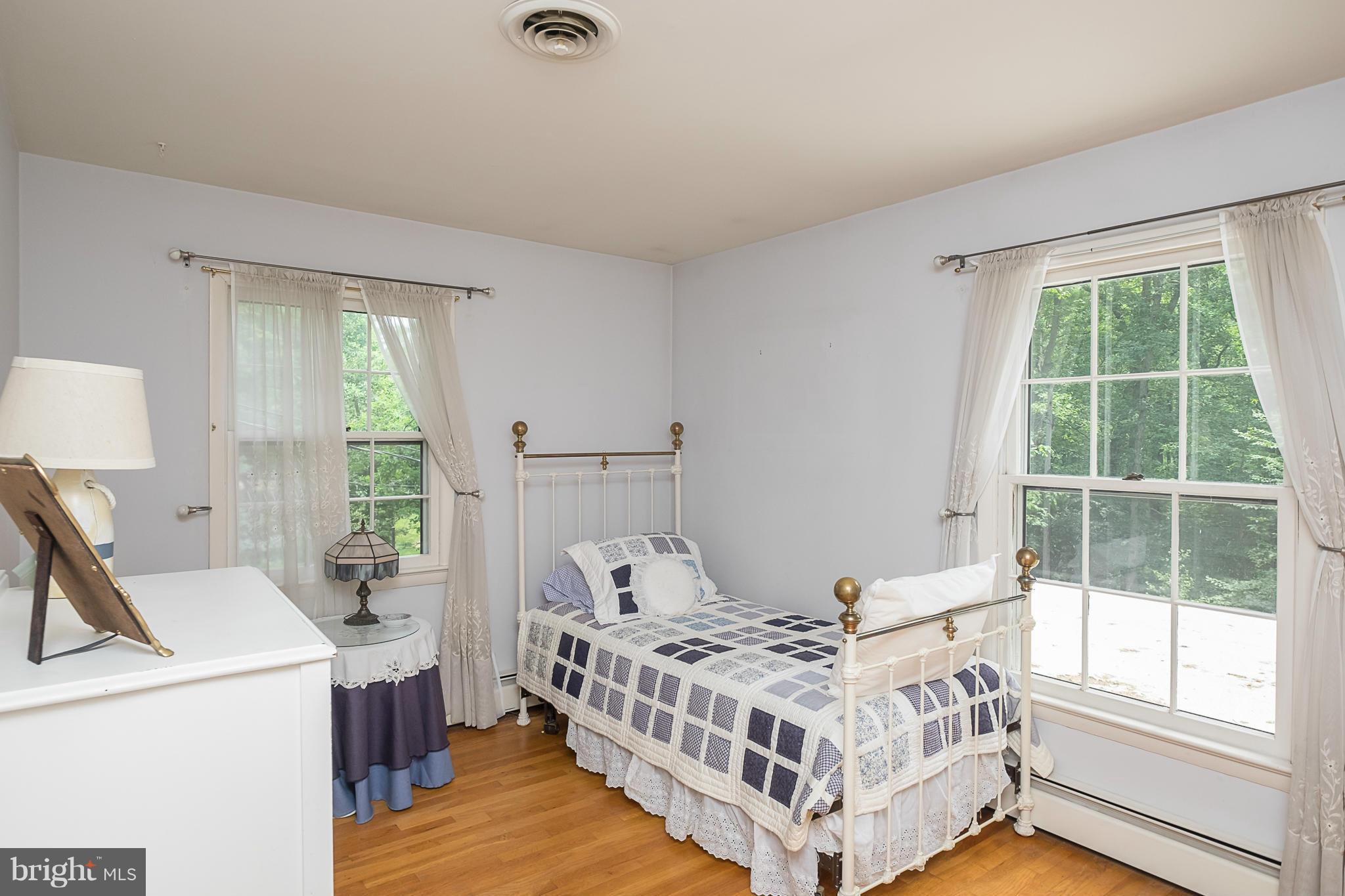 10836 Harding Road Laurel, MD 20723 - Photo 16 of 25 a bed room with a bed and a window