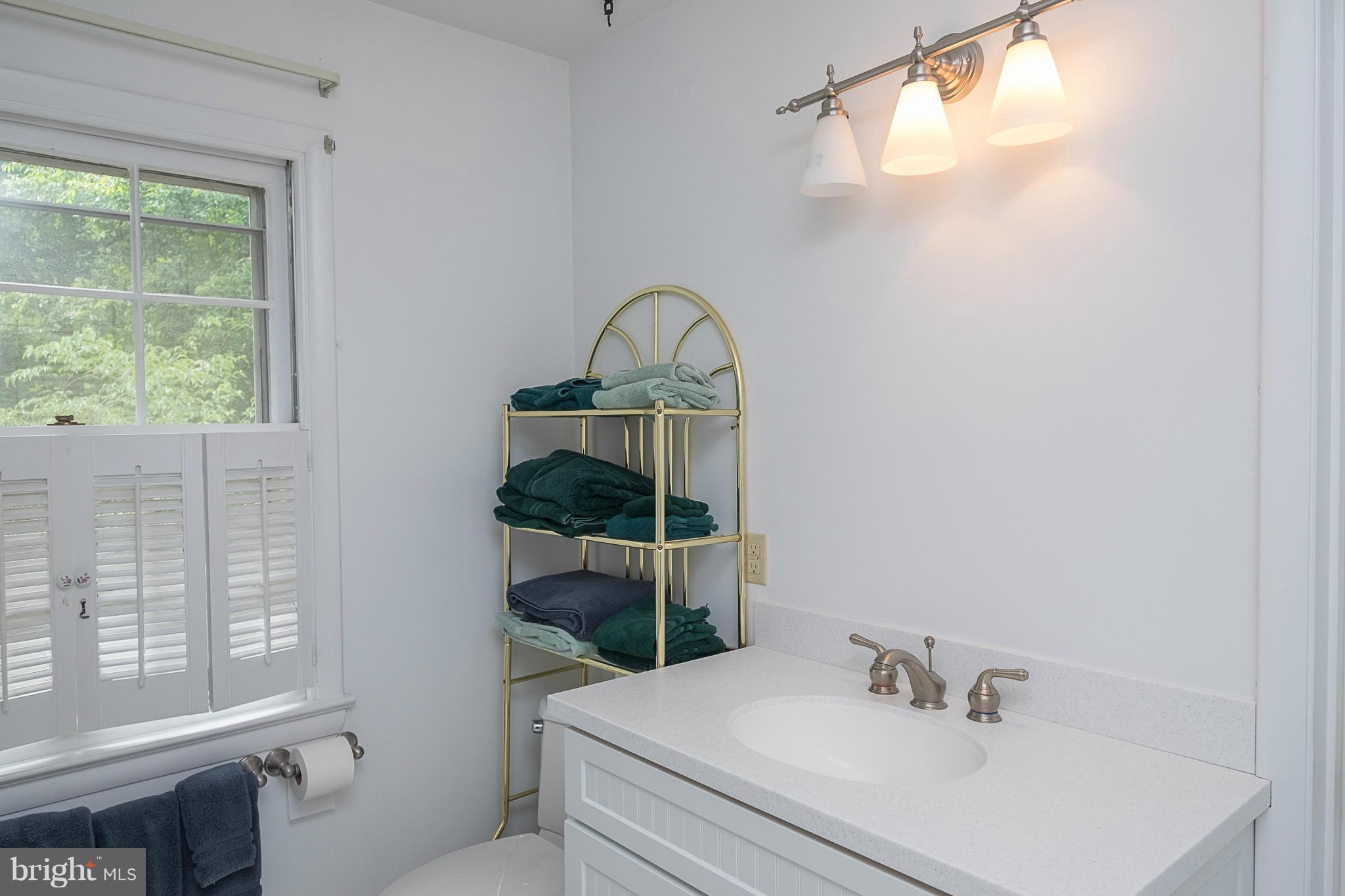 10836 Harding Road Laurel, MD 20723 - Photo 17 of 25 a bathroom with a sink a toilet and a window