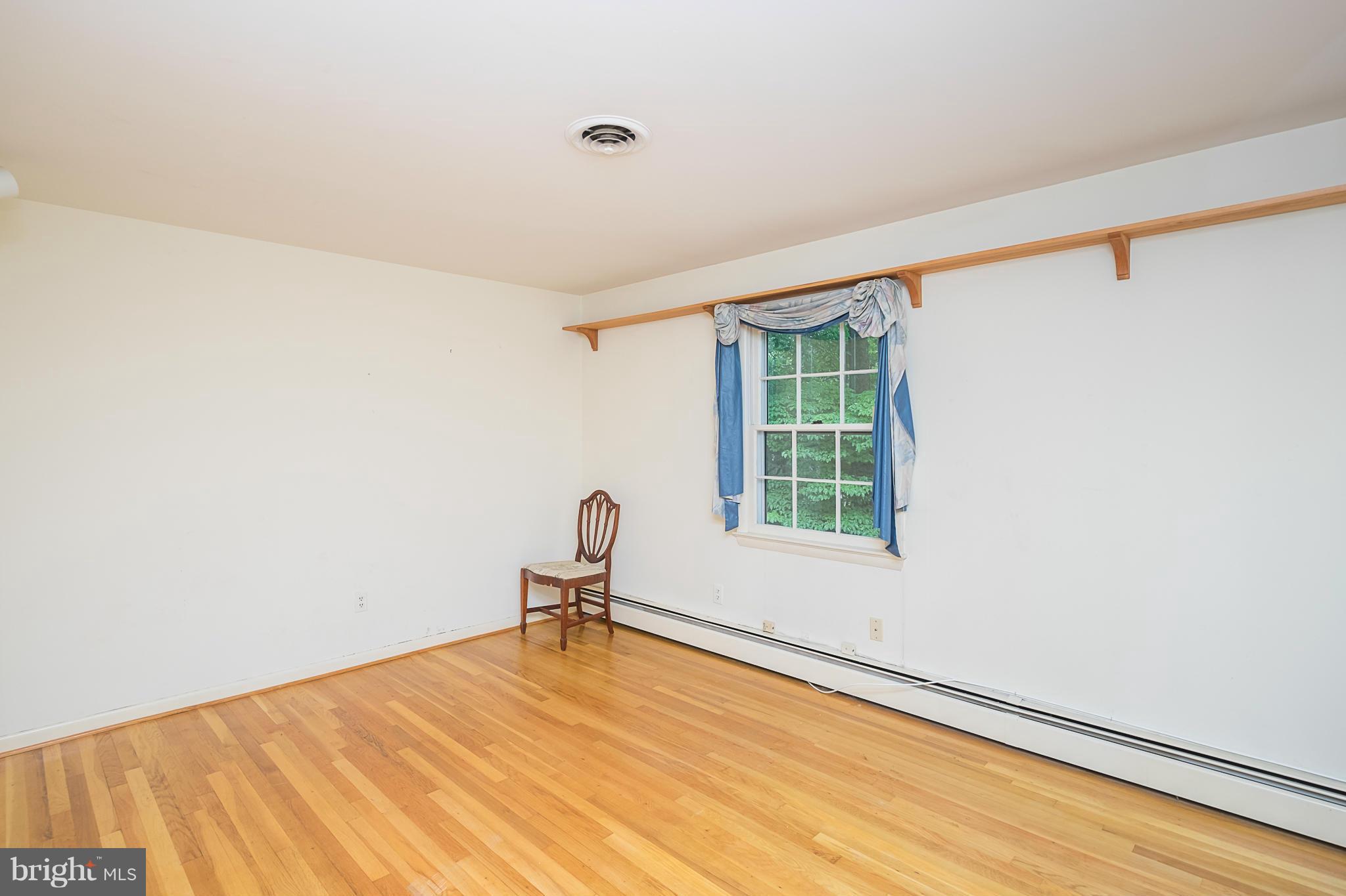 10836 Harding Road Laurel, MD 20723 - Photo 18 of 25 a view of a room with a window and wooden floor