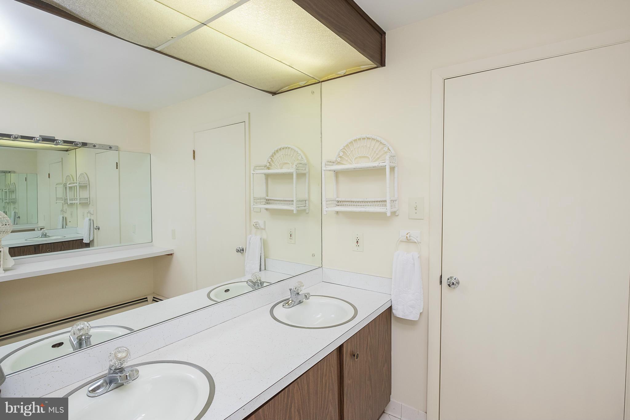 10836 Harding Road Laurel, MD 20723 - Photo 19 of 25 a bathroom with a sink and a mirror