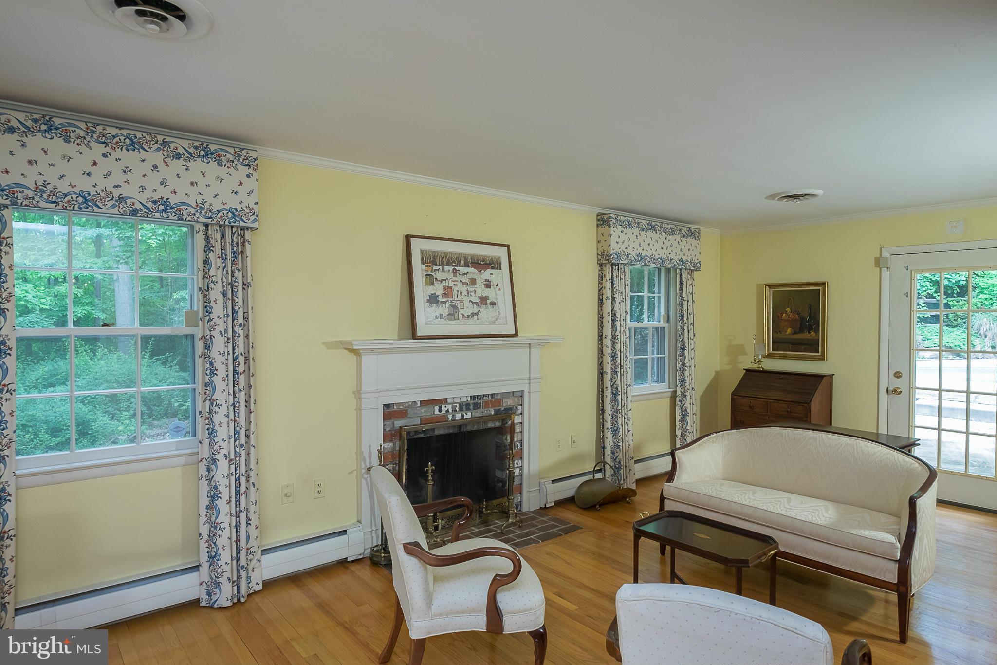 10836 Harding Road Laurel, MD 20723 - Photo 3 of 25 a living room with furniture a fireplace and a window
