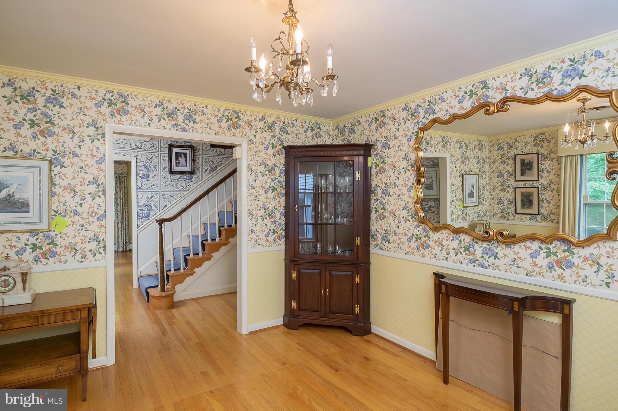 10836 Harding Road Laurel, MD 20723 - Photo 4 of 25 a view of a hallway with wooden floor and staircase