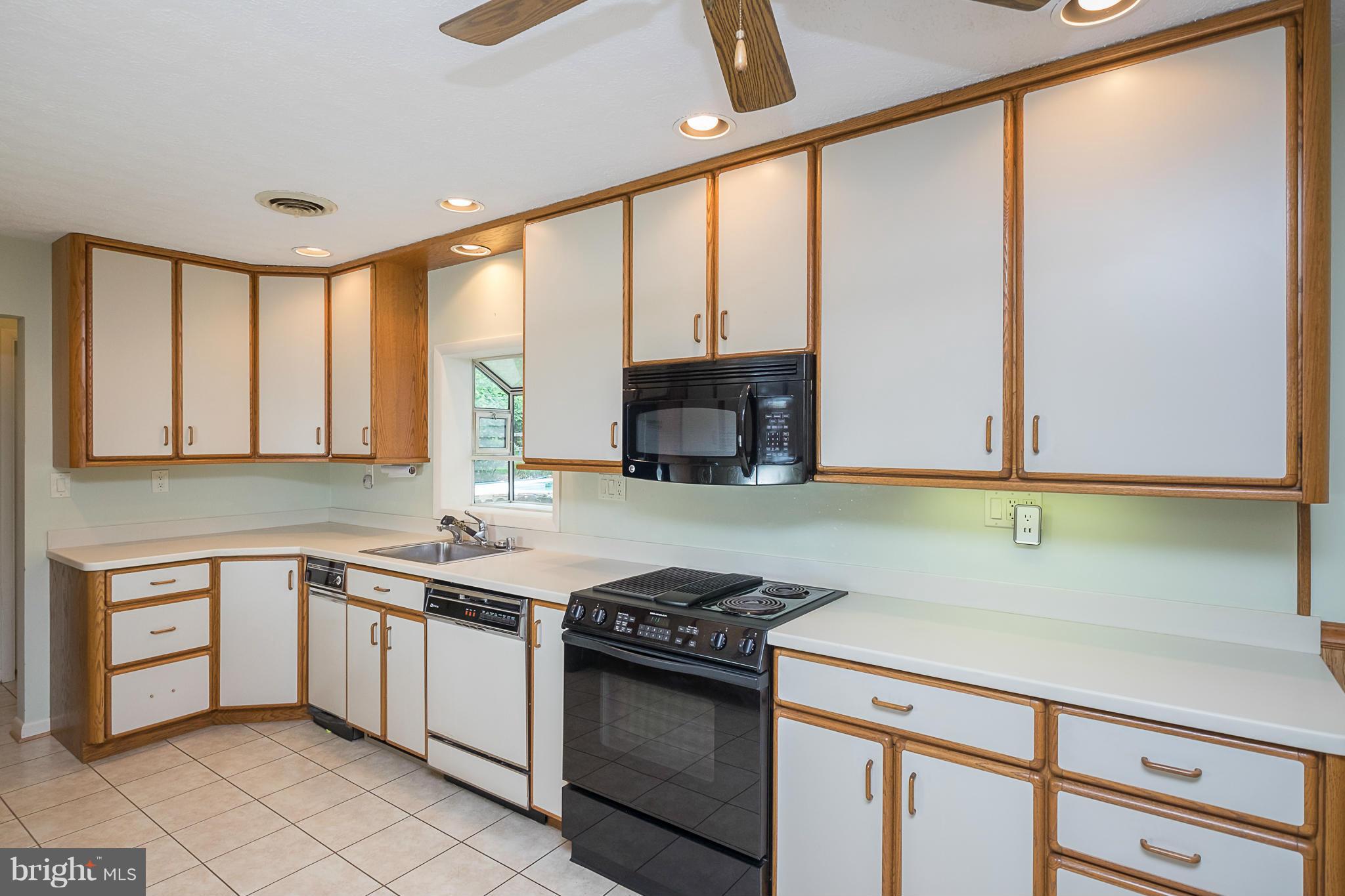 10836 Harding Road Laurel, MD 20723 - Photo 5 of 25 a kitchen with a sink and a stove top oven