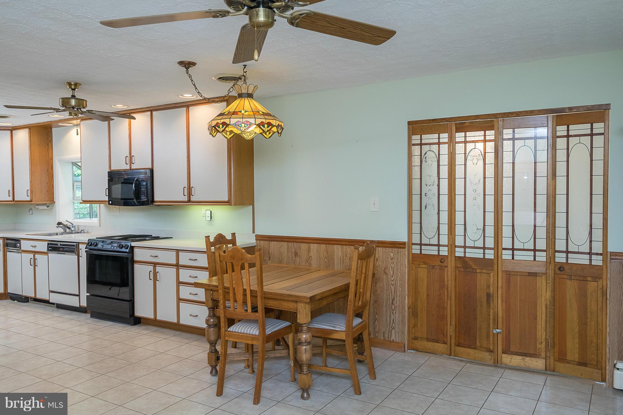 10836 Harding Road Laurel, MD 20723 - Photo 6 of 25 a kitchen with stainless steel appliances granite countertop a sink and a stove