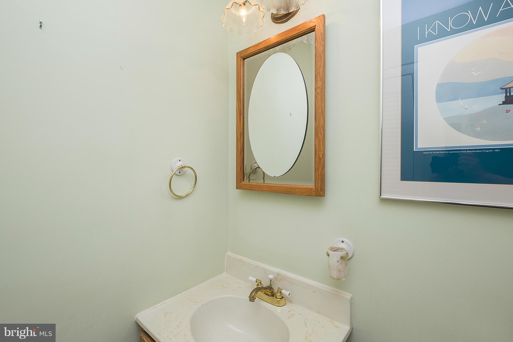 10836 Harding Road Laurel, MD 20723 - Photo 7 of 25 a bathroom with a sink and a mirror