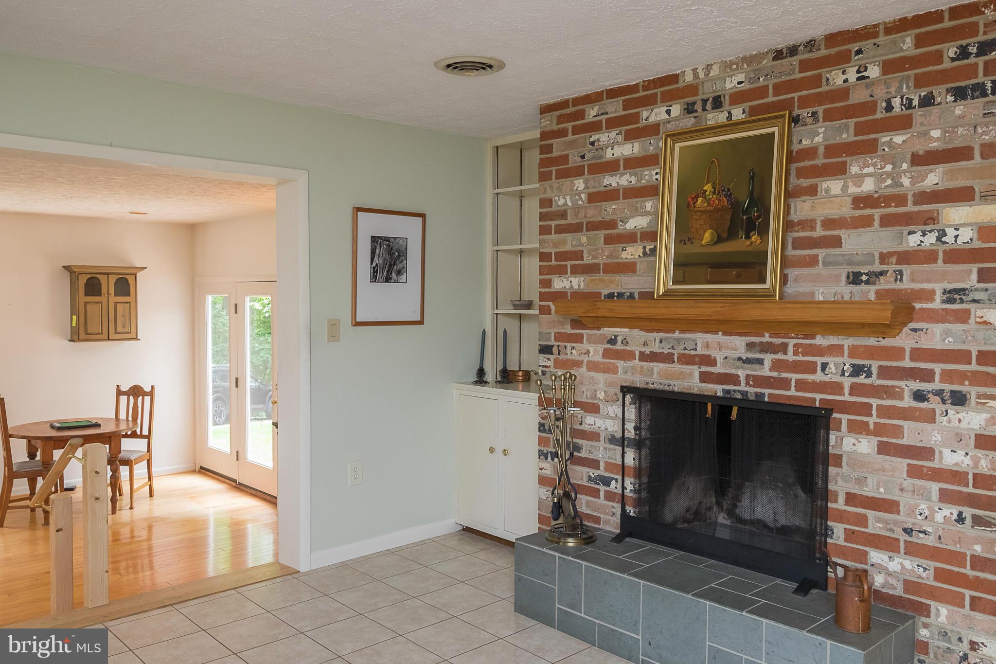10836 Harding Road Laurel, MD 20723 - Photo 8 of 25 a living room with a fireplace and a floor to ceiling window