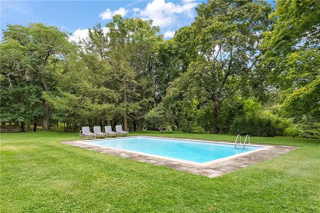 a roof deck with couches and pool