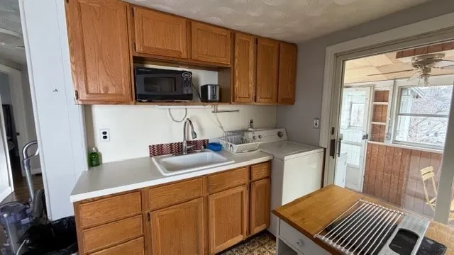 a kitchen with a sink and cabinets