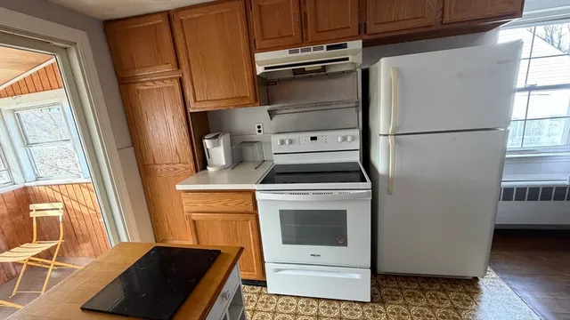 a kitchen with a refrigerator stove and sink