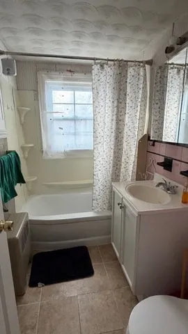 a bathroom with a sink a toilet and tub