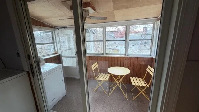 a view of a room with wooden floor and seating space