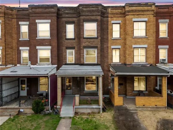 a front view of a residential apartment building with a yard