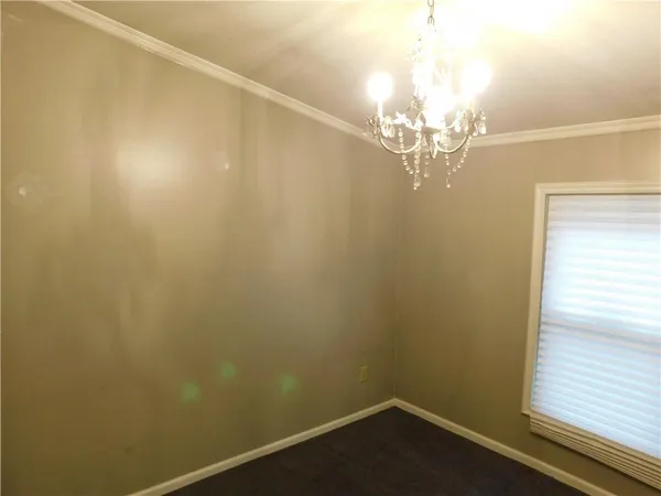 a view of a room with a chandelier fan