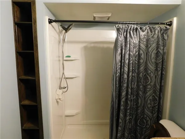 a bathroom with a shower and a glass door