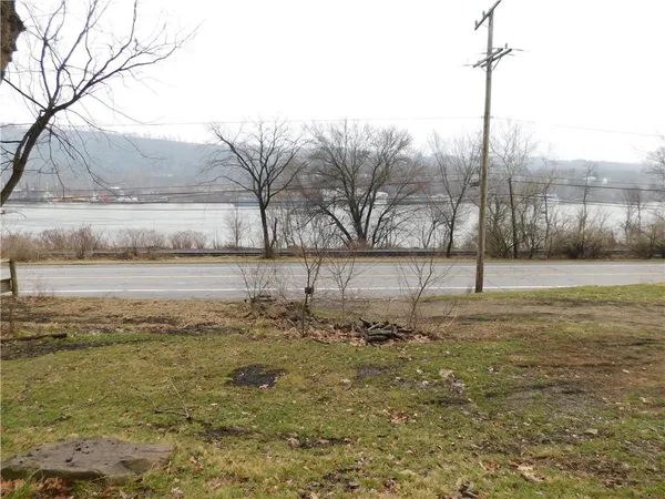 a view of a yard with wooden fence