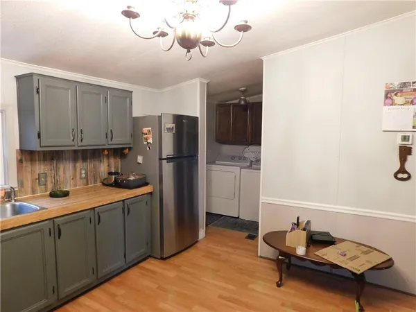 a kitchen with a refrigerator and a sink