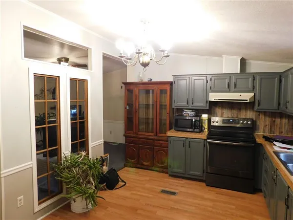a kitchen with granite countertop stainless steel appliances and wooden cabinets
