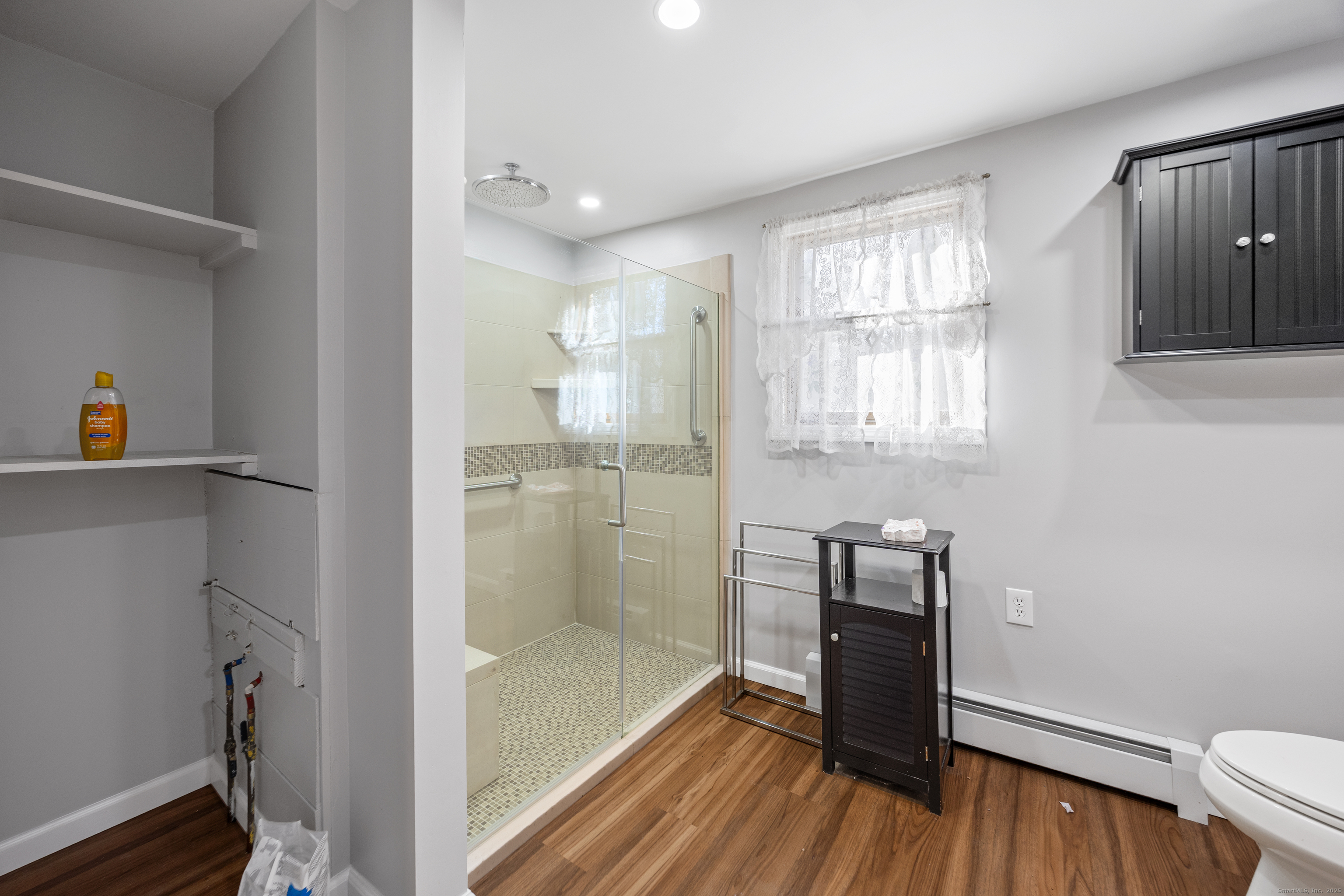 1557 Wolcott Road Wolcott, CT 06716 - Photo 12 of 18 a bathroom with a sink and a mirror