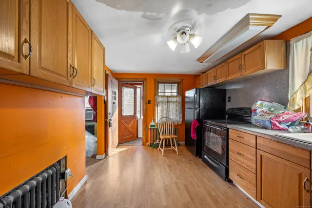 a view of a livingroom with wooden floor and furniture