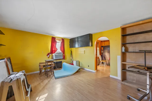 a living room with furniture pool table and stainless steel appliances
