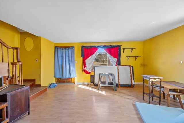 a view of a livingroom with furniture and a window