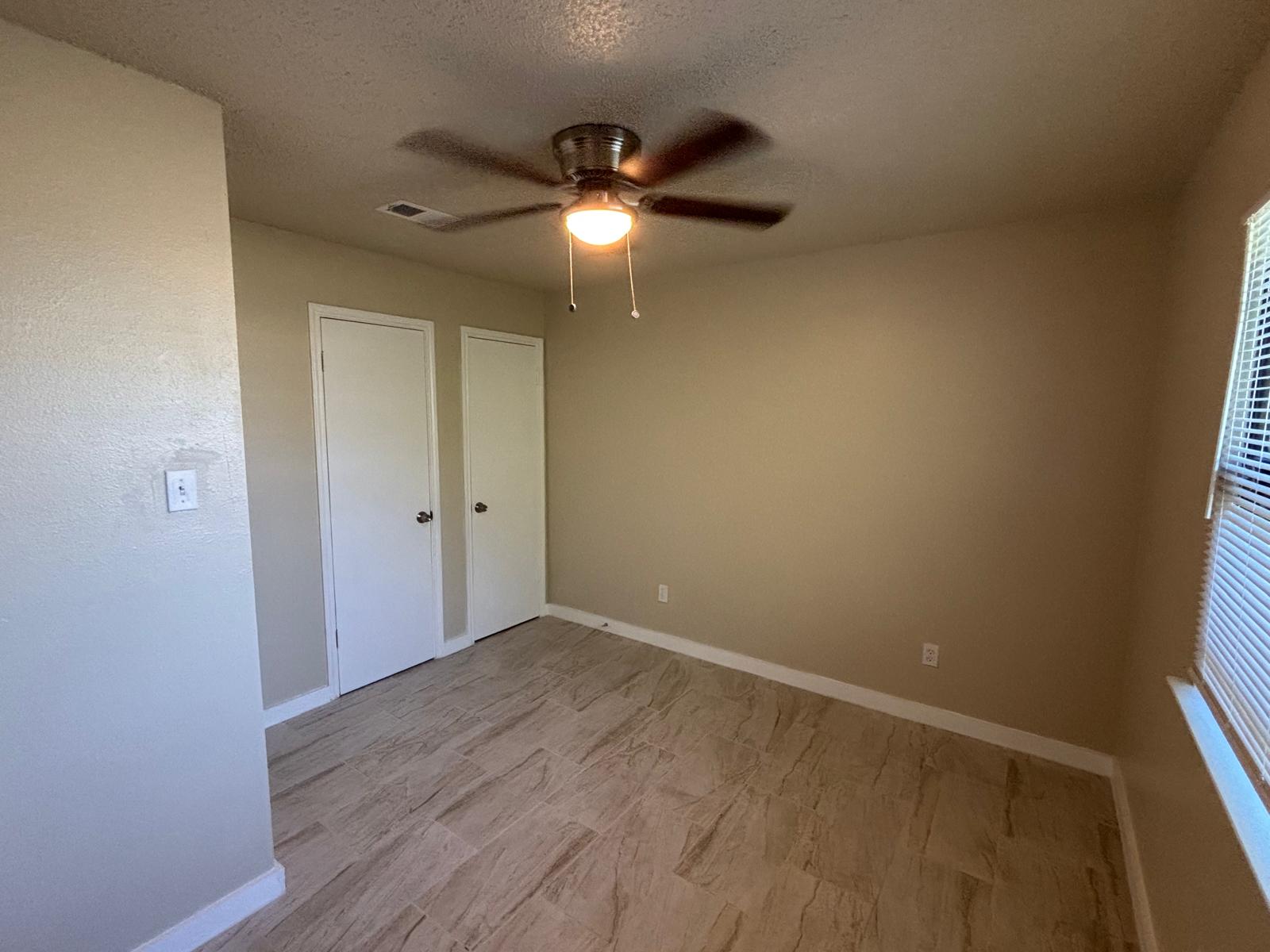4609 East 12th Street, Unit 4 Austin, TX 78721 - Photo 10 of 14 Gleaming tile floors and clean modern baseboards frame this versatile living space.
