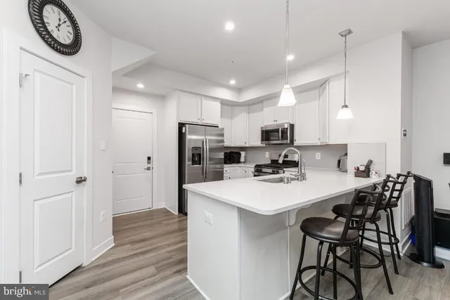 a kitchen with stainless steel appliances a stove sink microwave and cabinets