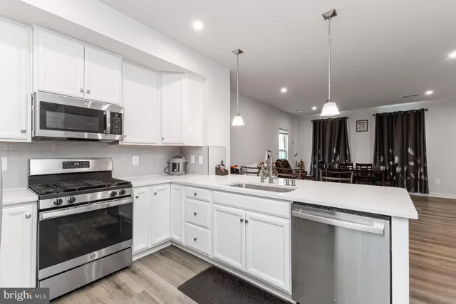 a kitchen with a sink and a stove top oven