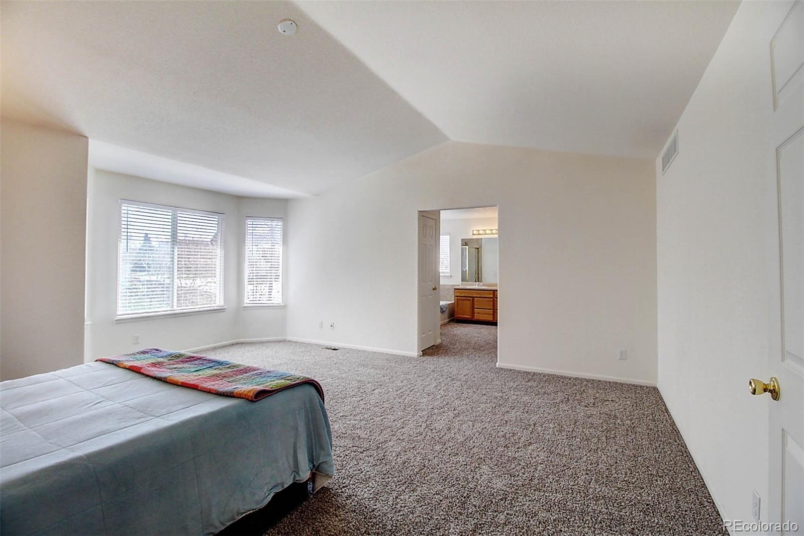 5794 South Rome Street Aurora, CO 80015 - Photo 18 of 37 a bedroom with a bed and a window