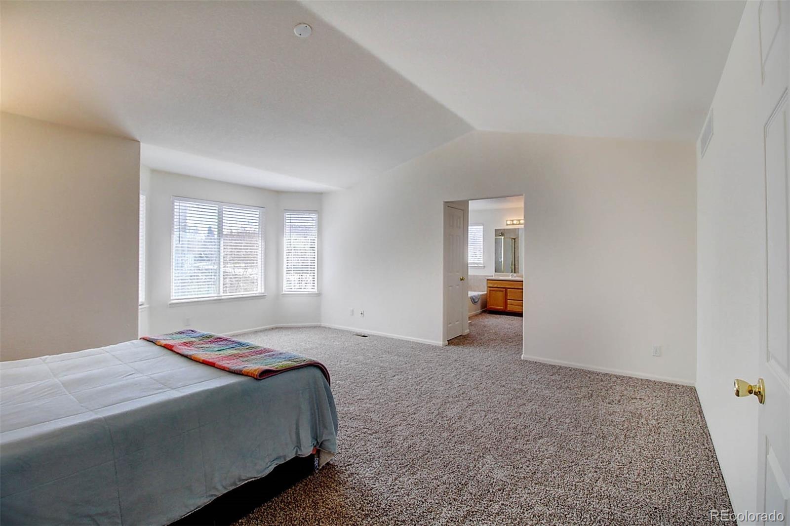 5794 South Rome Street Aurora, CO 80015 - Photo 19 of 37 a bedroom with a bed and window
