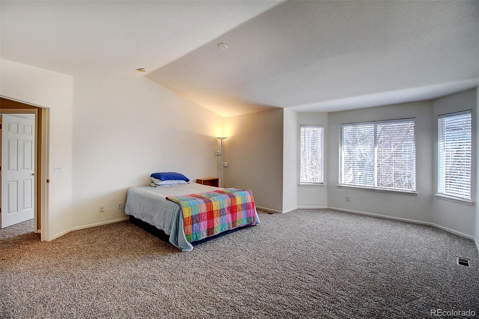 5794 South Rome Street Aurora, CO 80015 - Photo 21 of 37 a bedroom with a bed and window