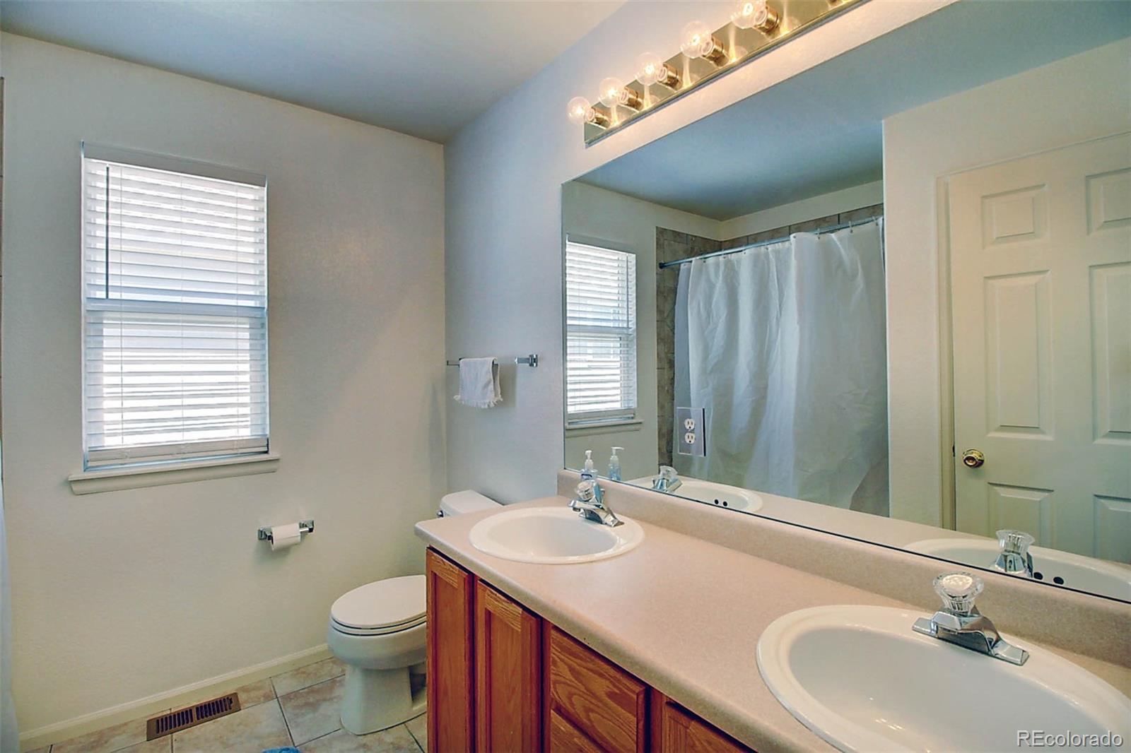 5794 South Rome Street Aurora, CO 80015 - Photo 26 of 37 a bathroom with a sink and a mirror