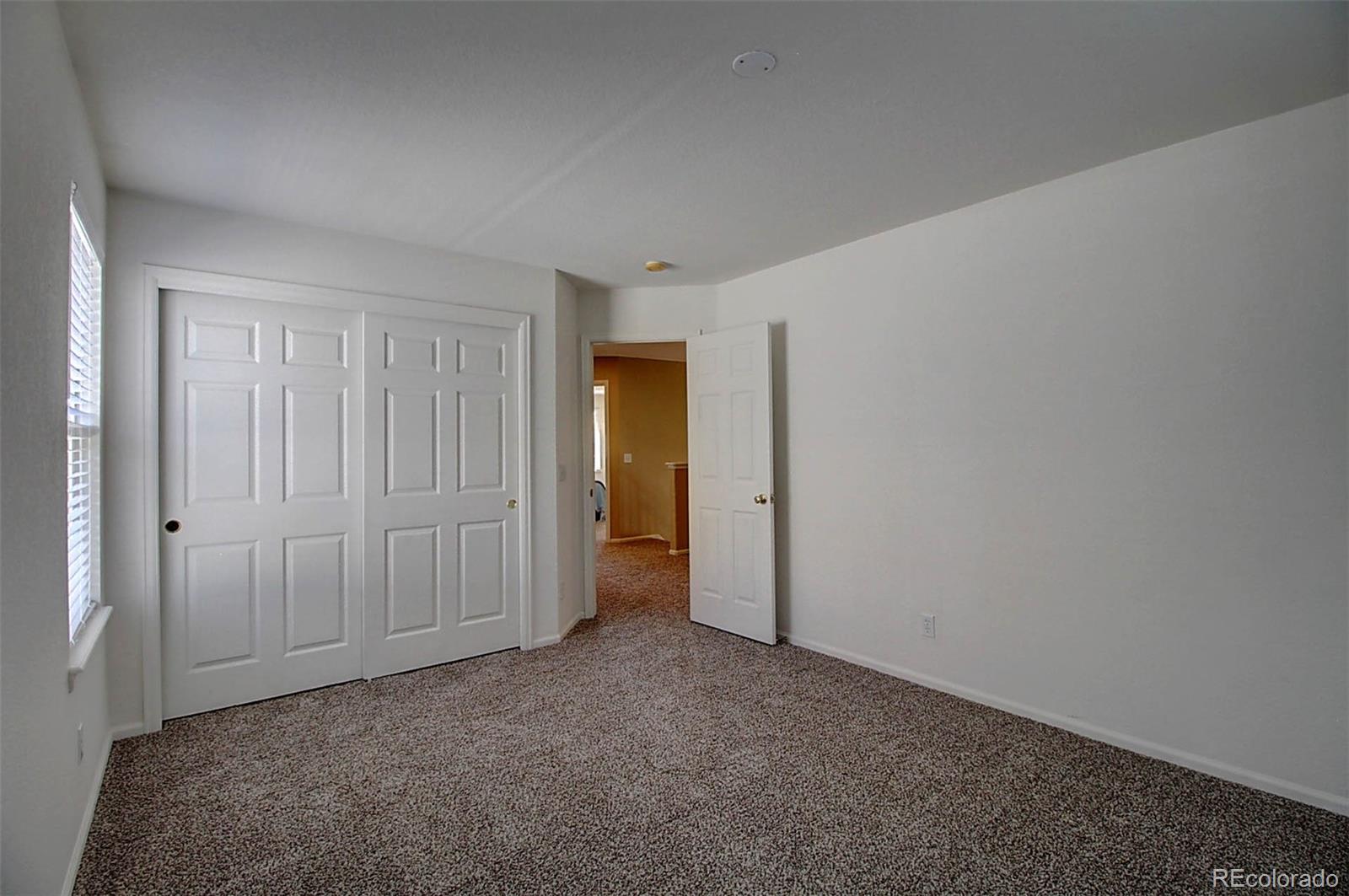5794 South Rome Street Aurora, CO 80015 - Photo 28 of 37 a view of an empty room and closet area