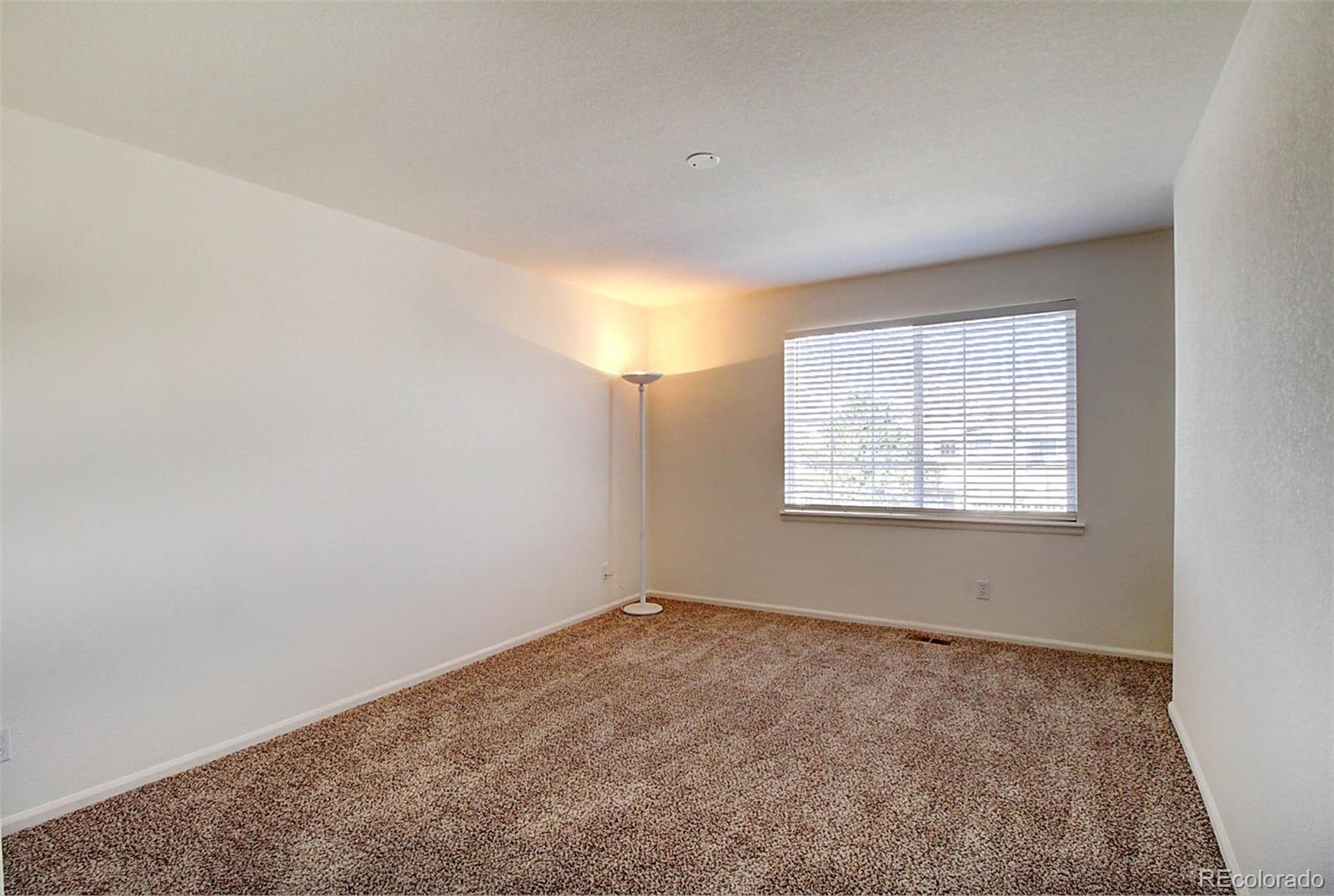 5794 South Rome Street Aurora, CO 80015 - Photo 29 of 37 an empty room with a empty space and windows