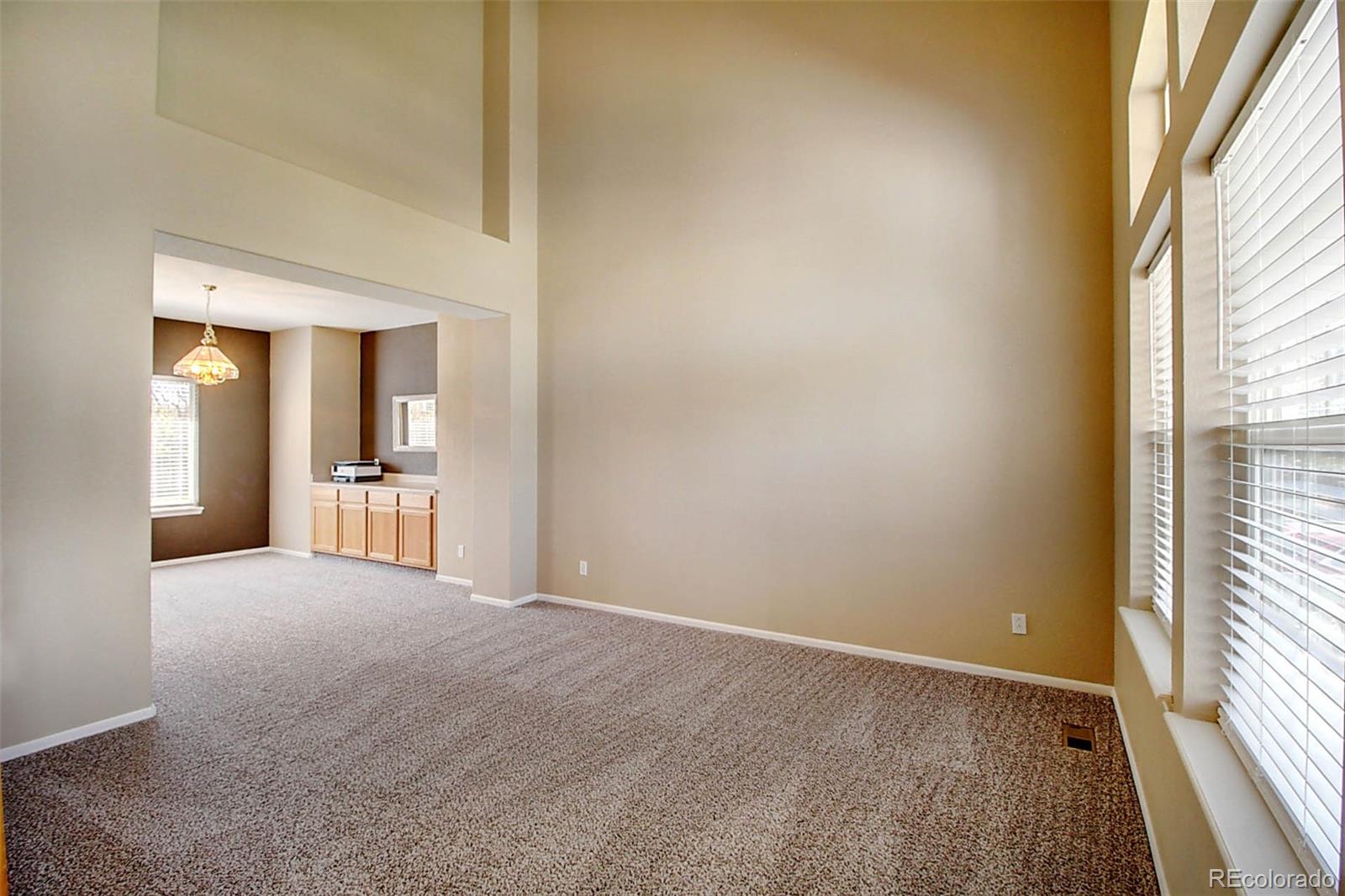 5794 South Rome Street Aurora, CO 80015 - Photo 3 of 37 a view of a big room with windows and entryway