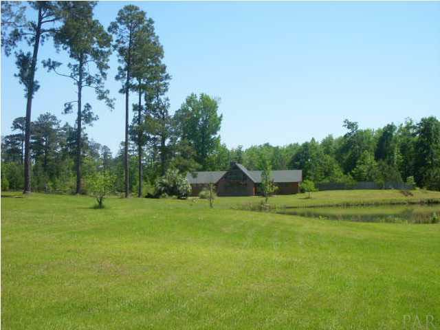 740 Freedom Road Century, FL 32535 - Photo 1 of 19 FRONT VIEW OF HOME AND POND