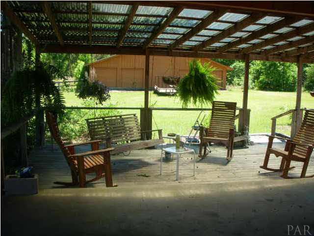 740 Freedom Road Century, FL 32535 - Photo 6 of 19 SITTING AREA OFF OF CARPORT