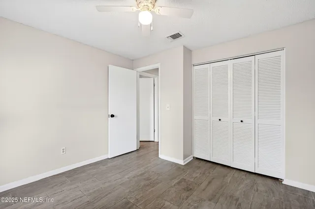an empty room with a window and wooden floor