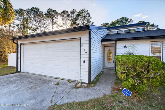 an aerial view of a house with a garden