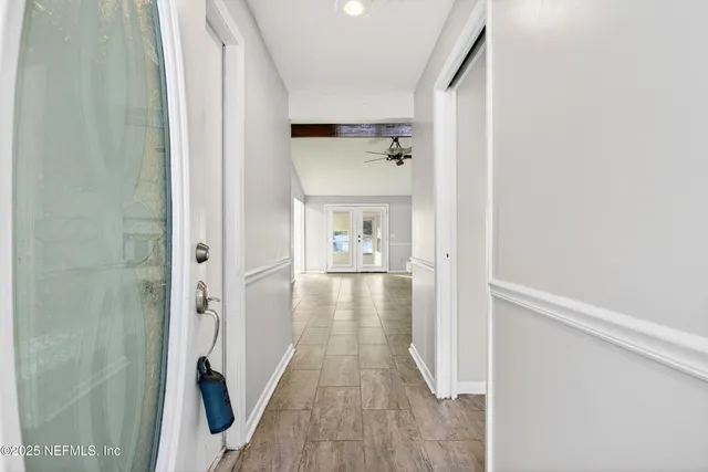 a view of an empty room with a fireplace and a window