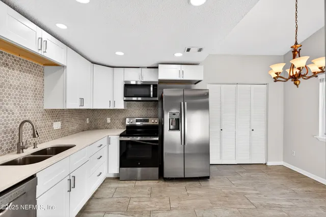 a kitchen with a refrigerator and a sink