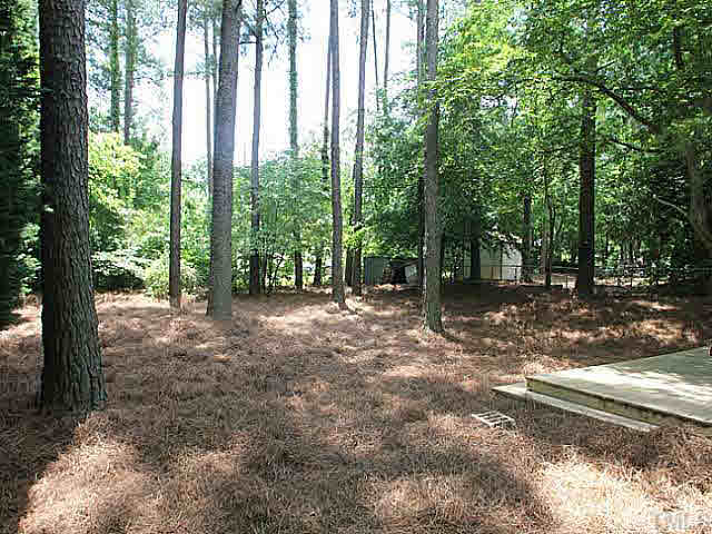 2113 Mariner Circle Raleigh, NC 27603 - Photo 13 of 13 Freshly mulched with pine straw, open but shaded back yard.