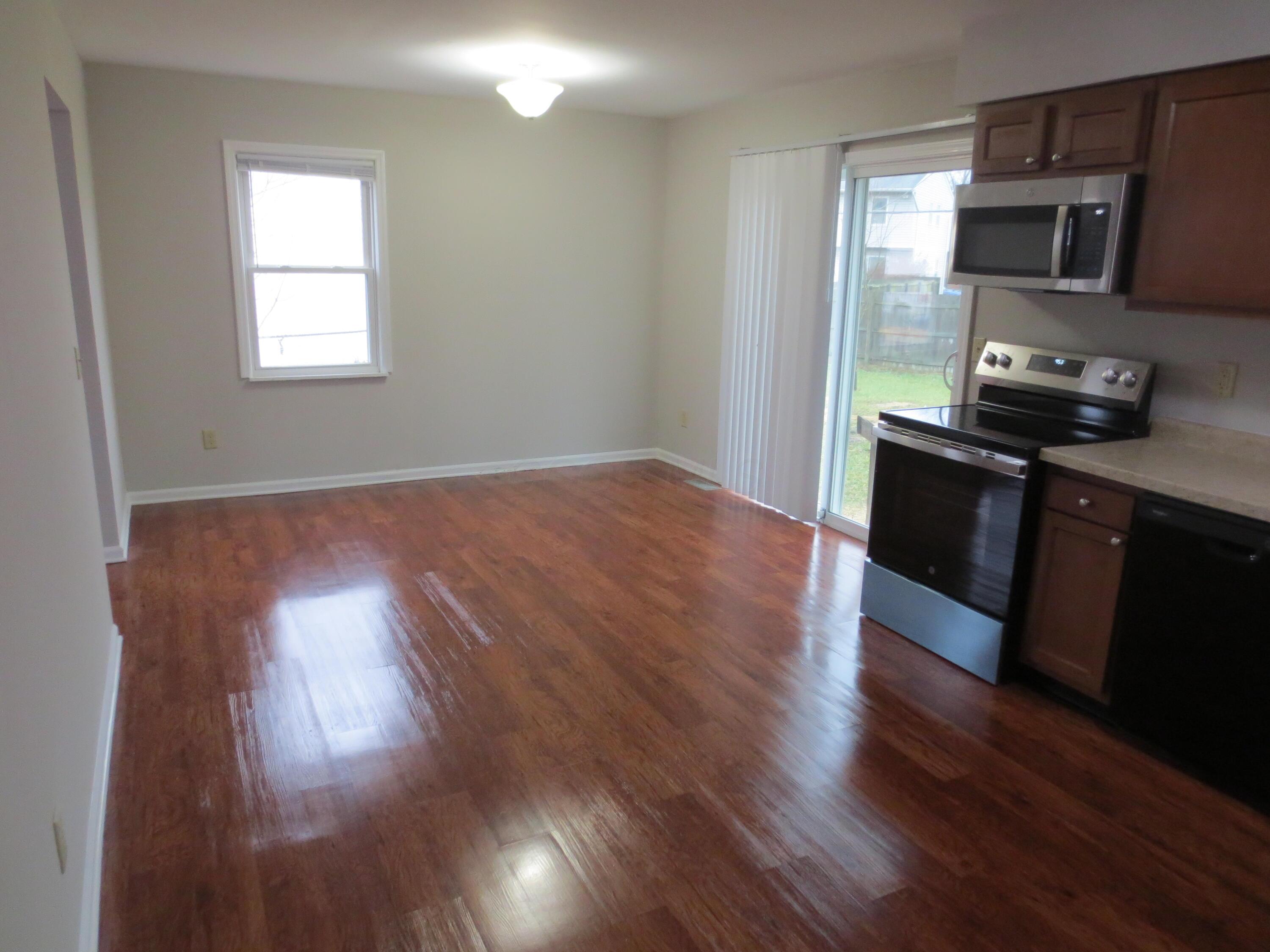 Kitchen looking at Dining area. Beautiful vinyl flooring. Sliding door to back yard. Also space for eat in kitchen