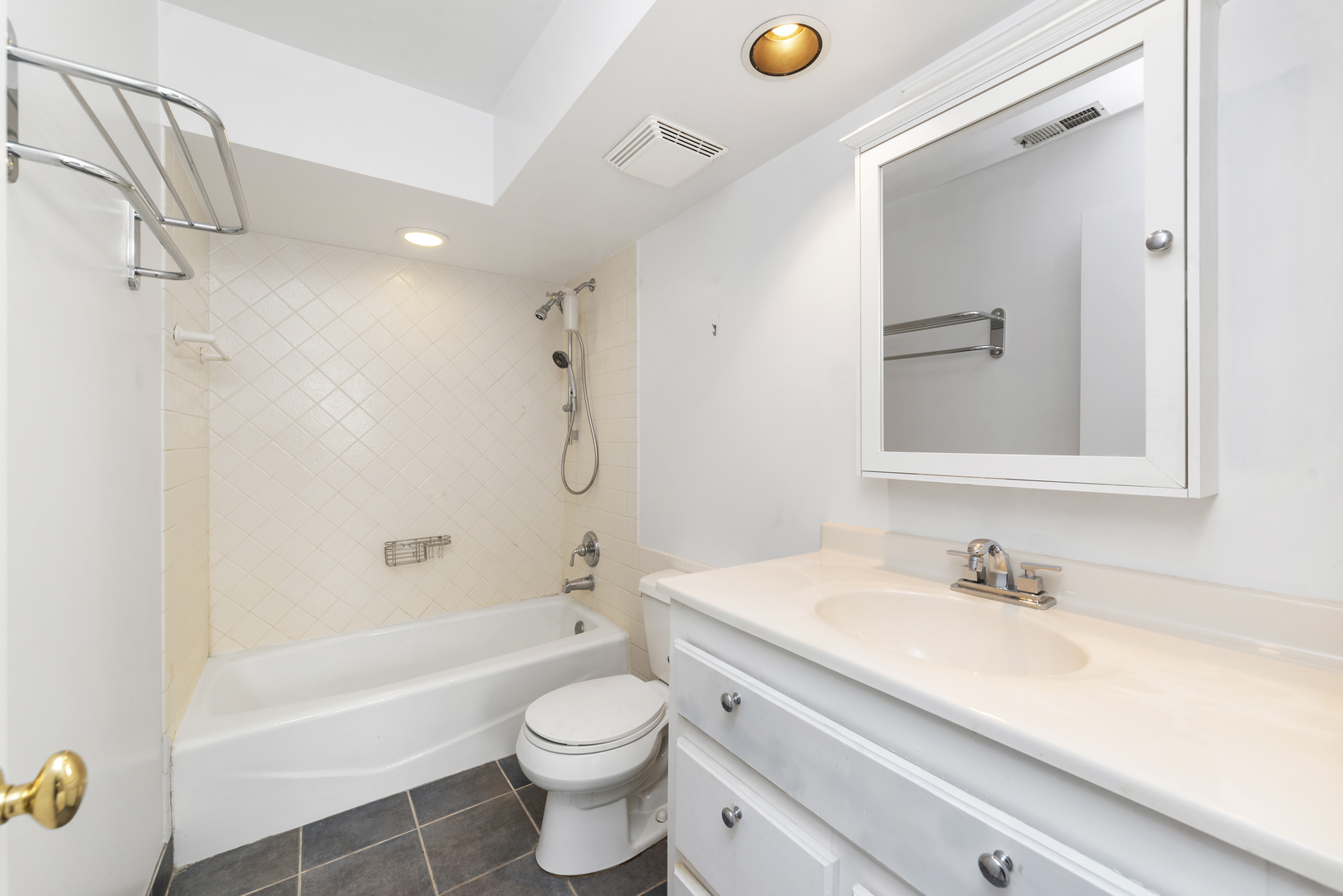 1-s150 Spring Road, Unit 2D Oak Brook, IL 60181 - Photo 17 of 22 a bathroom with a sink a toilet and a mirror