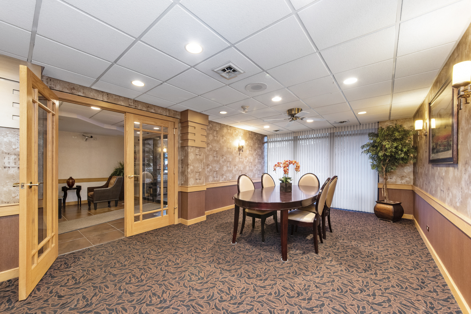 1-s150 Spring Road, Unit 2D Oak Brook, IL 60181 - Photo 20 of 22 a dining room with furniture a rug and a chandelier