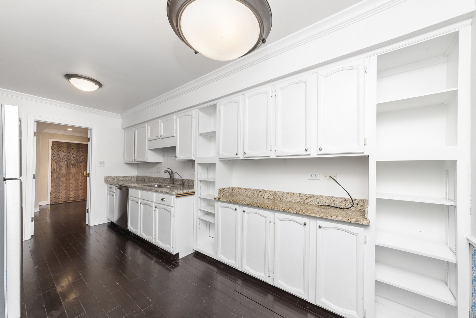 1-s150 Spring Road, Unit 2D Oak Brook, IL 60181 - Photo 7 of 22 a kitchen with stainless steel appliances granite countertop a stove sink and cabinets