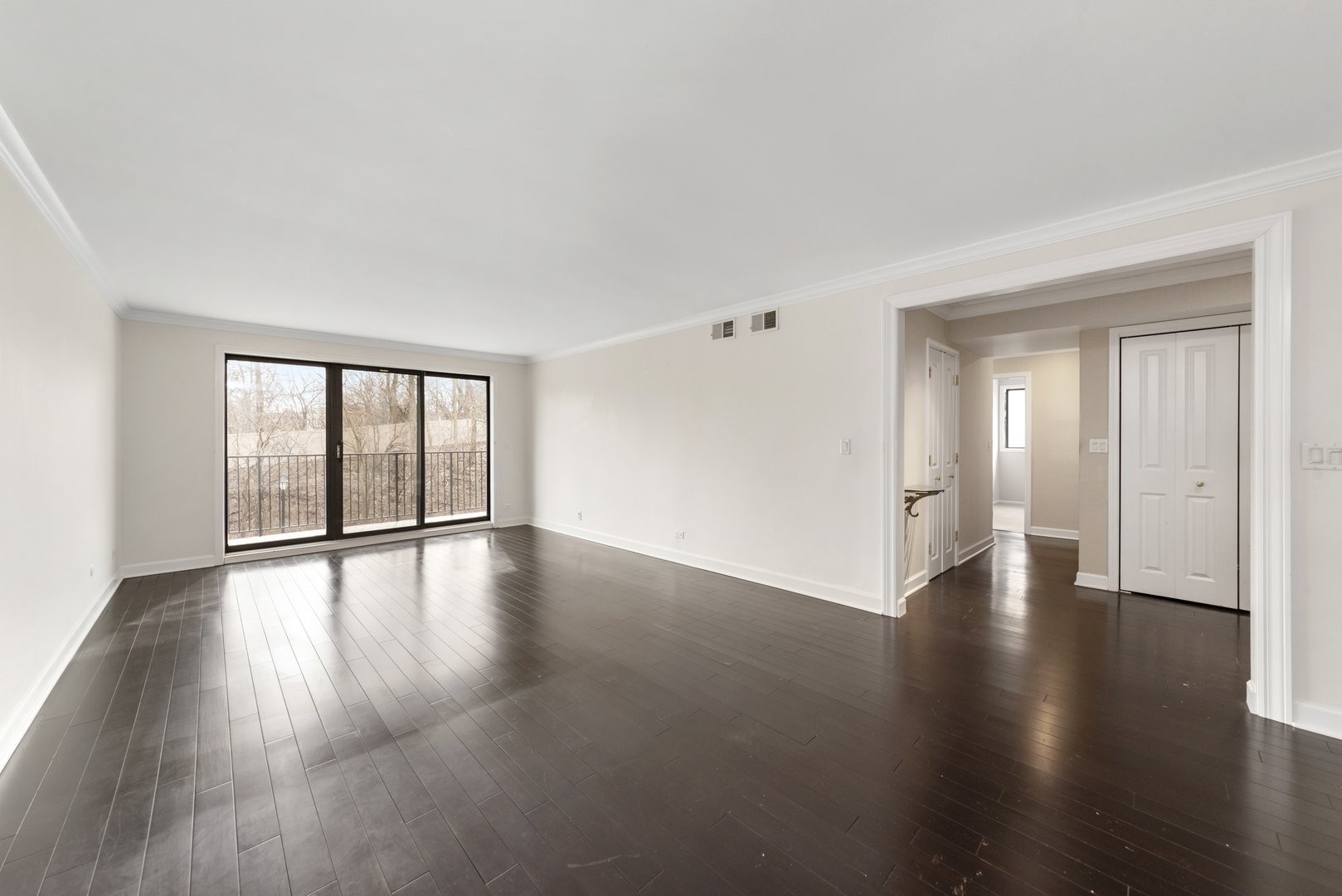 1-s150 Spring Road, Unit 2D Oak Brook, IL 60181 - Photo 10 of 22 a view of an empty room with wooden floor and a window