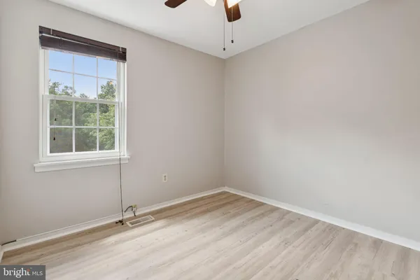 an empty room with a empty space and windows