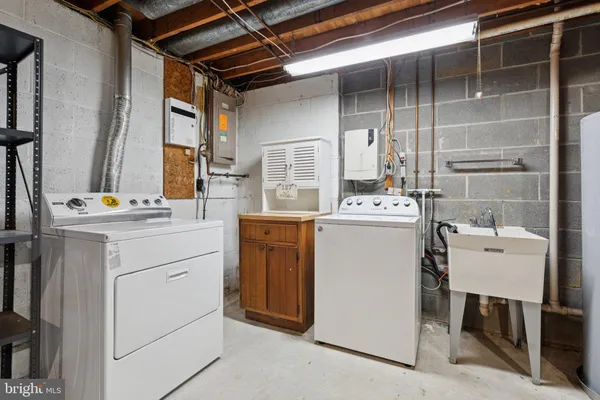 a utility room with closet dryer and washer